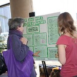 Student explains poster presentation to another conference participant